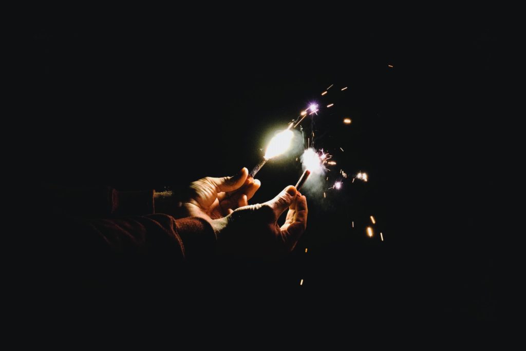 person holding two sparklers